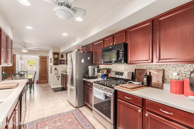 kitchen featuring a ceiling fan, light tile patterned floors, appliances with stainless steel finishes, and light countertops