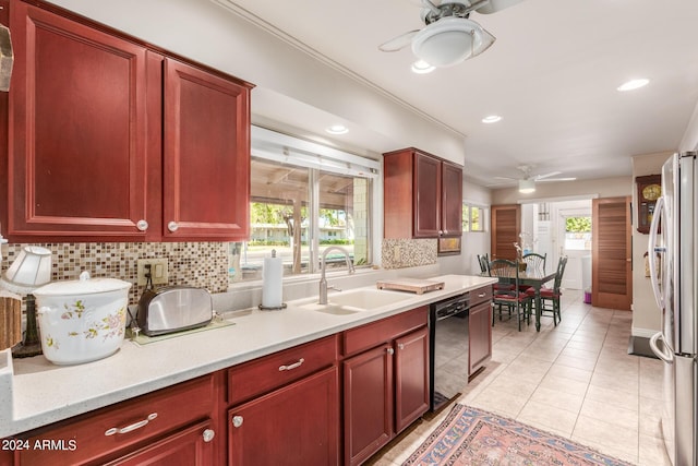 kitchen featuring a ceiling fan, freestanding refrigerator, a sink, and black dishwasher
