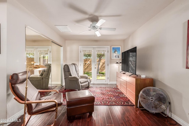 sitting room with wood finished floors, a healthy amount of sunlight, baseboards, and french doors