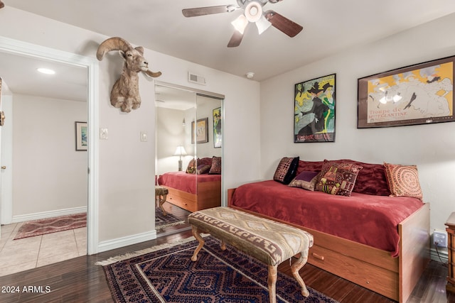 bedroom with ceiling fan, hardwood / wood-style flooring, and a closet