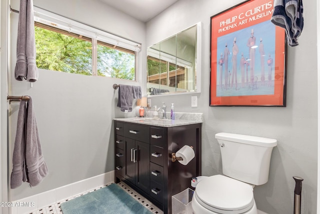 bathroom with visible vents, baseboards, vanity, and toilet