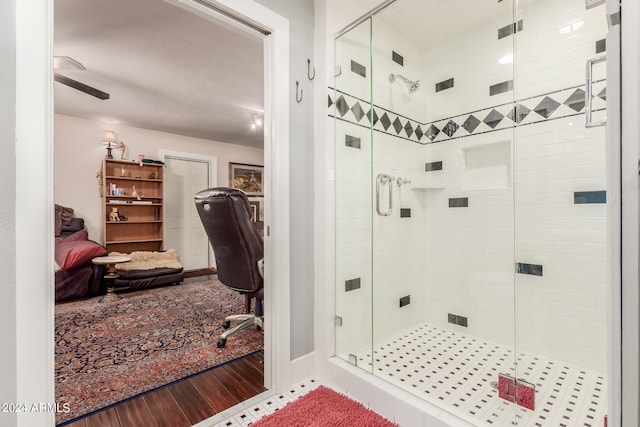 bathroom featuring wood-type flooring and a shower with shower door