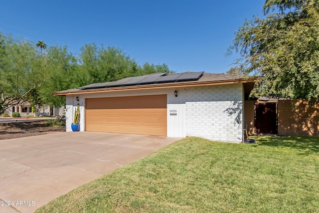exterior space featuring roof mounted solar panels and driveway
