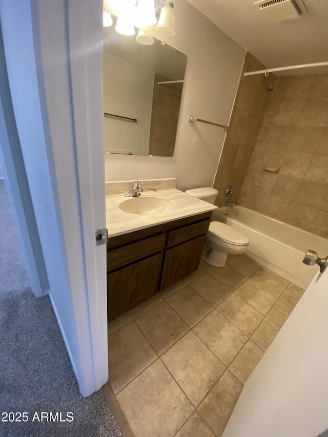 bathroom with visible vents, toilet, tile patterned floors, tub / shower combination, and vanity