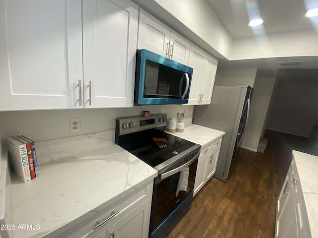 kitchen with white cabinets, stainless steel appliances, and dark wood-type flooring