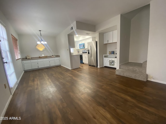 kitchen featuring dark wood finished floors, stainless steel appliances, visible vents, white cabinetry, and a chandelier