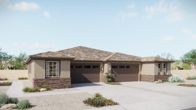 5633 N 205th Ln, Buckeye, AZ 85396 - prairie-style home featuring fence, concrete driveway, stucco siding, stone siding, and an attached garage