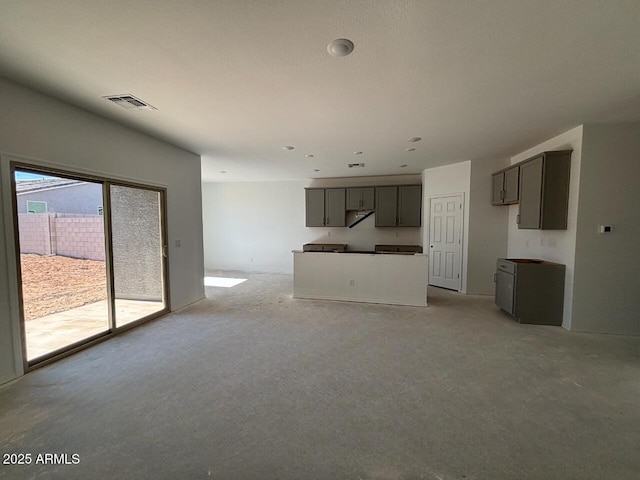 unfurnished living room featuring visible vents