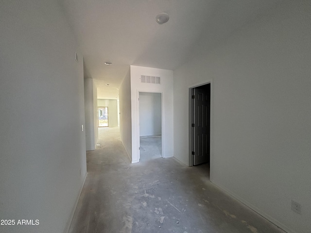 hallway with visible vents and concrete floors