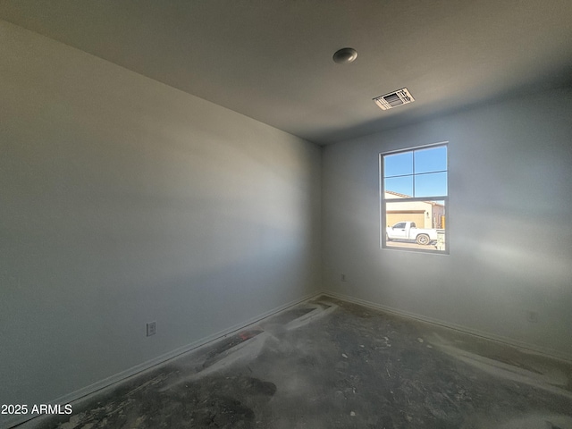 empty room with concrete floors and visible vents