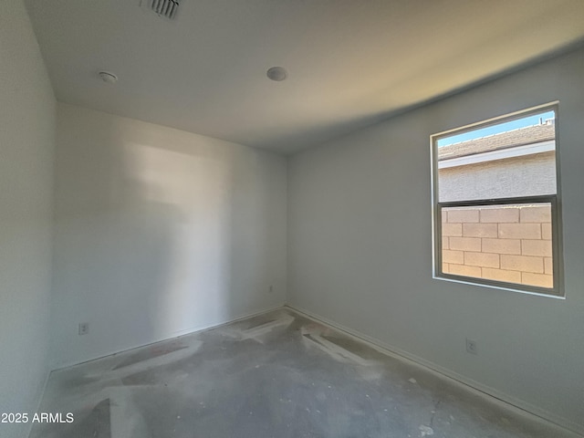 spare room featuring unfinished concrete flooring and visible vents