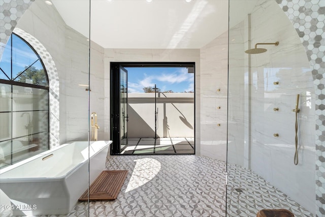 bathroom with a freestanding bath, walk in shower, tile walls, and lofted ceiling