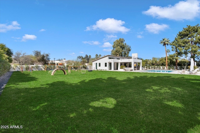 view of yard with a patio area, fence, and an outdoor pool