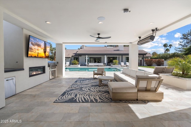 view of patio featuring an outdoor living space, an outdoor pool, a ceiling fan, and area for grilling