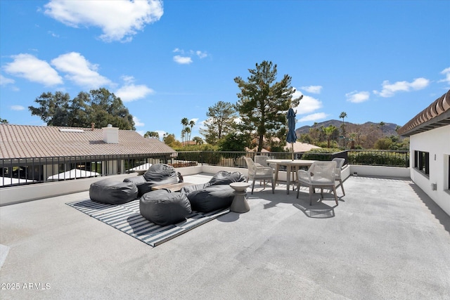 view of patio featuring outdoor dining space and a mountain view