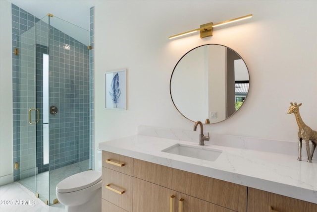 full bath featuring vanity, a shower stall, and toilet