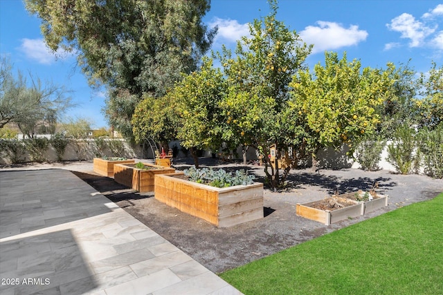 exterior space with fence and a garden