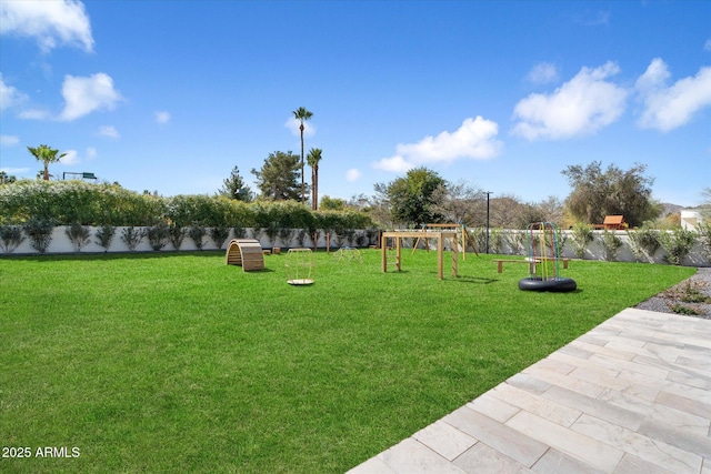 exterior space featuring a fenced backyard, a lawn, and playground community