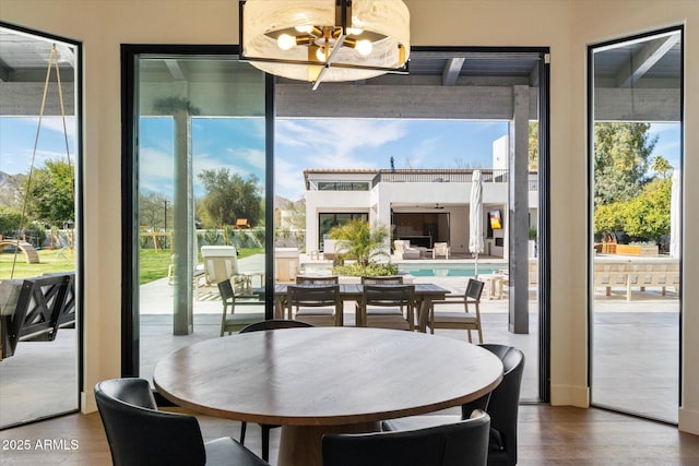 dining space with a healthy amount of sunlight and a notable chandelier