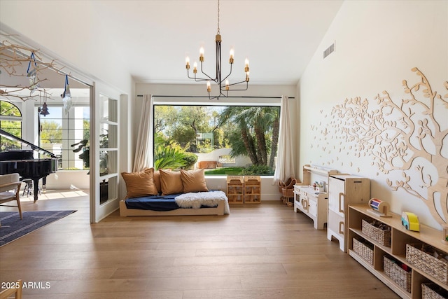 sitting room featuring visible vents, an inviting chandelier, and wood finished floors