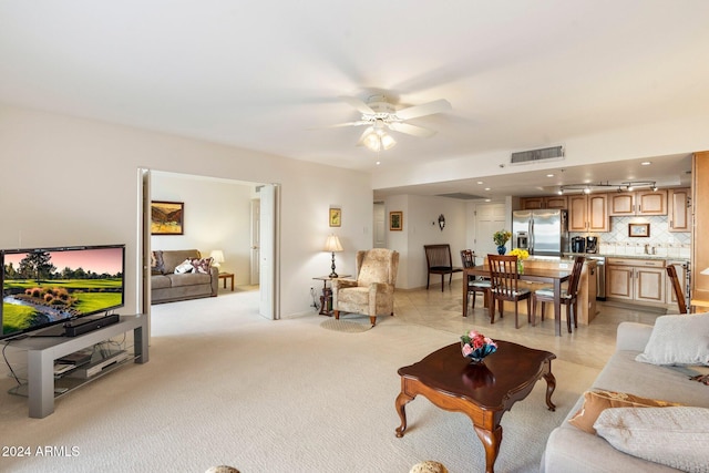 carpeted living room featuring ceiling fan