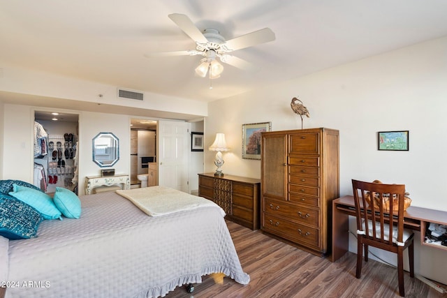 bedroom featuring a closet, ceiling fan, hardwood / wood-style floors, and a spacious closet