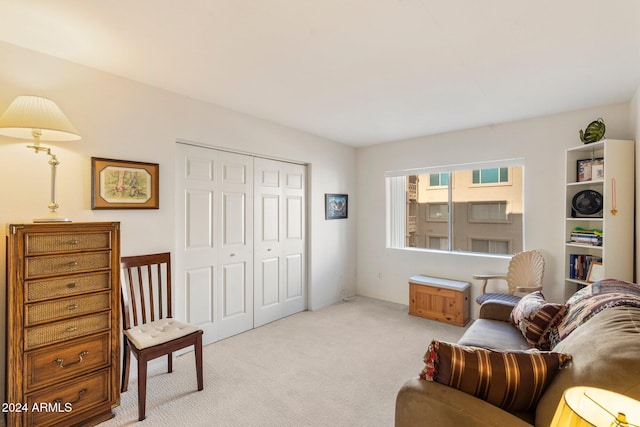 living area featuring light carpet