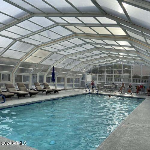 view of swimming pool featuring a lanai and a patio area