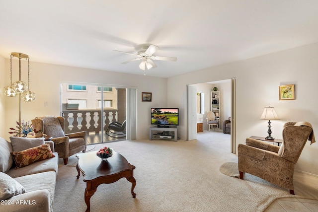 carpeted living room with ceiling fan