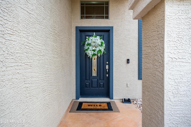 entrance to property featuring stucco siding