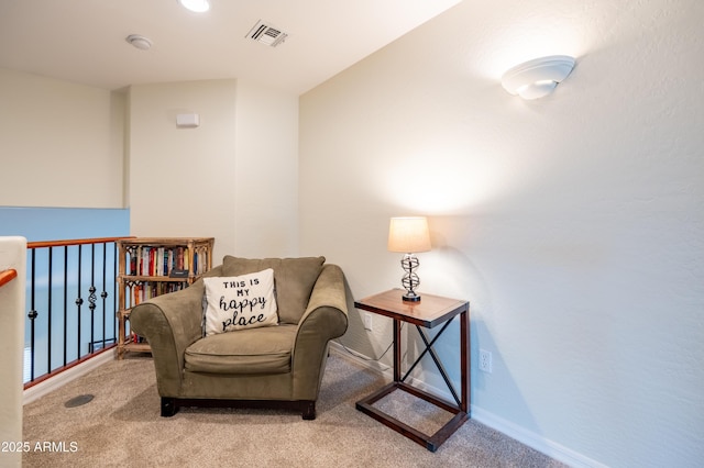 living area featuring carpet, visible vents, and baseboards