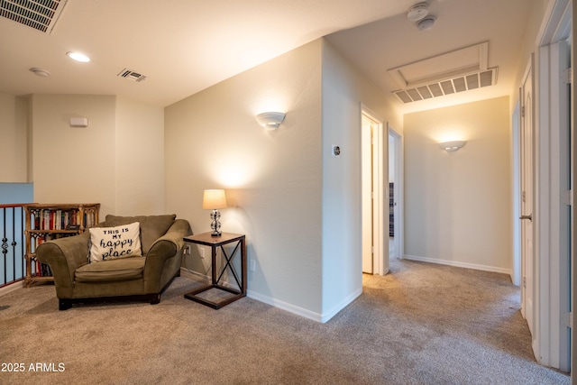 living area with carpet floors, baseboards, and visible vents