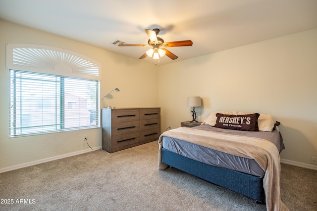 carpeted bedroom featuring baseboards, visible vents, and ceiling fan