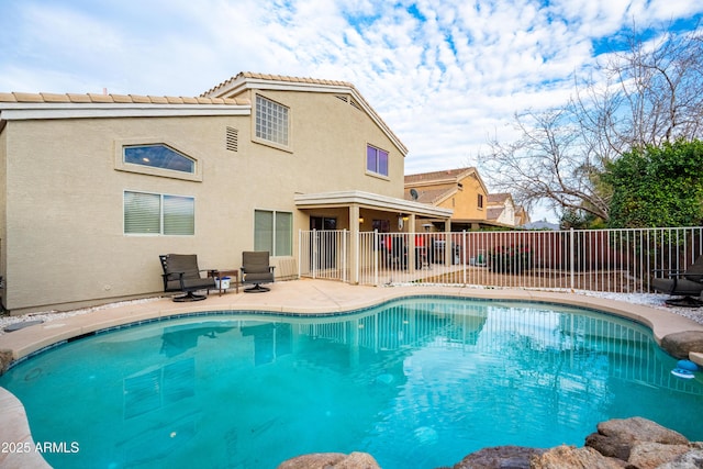 view of pool featuring a patio area, fence, and a fenced in pool