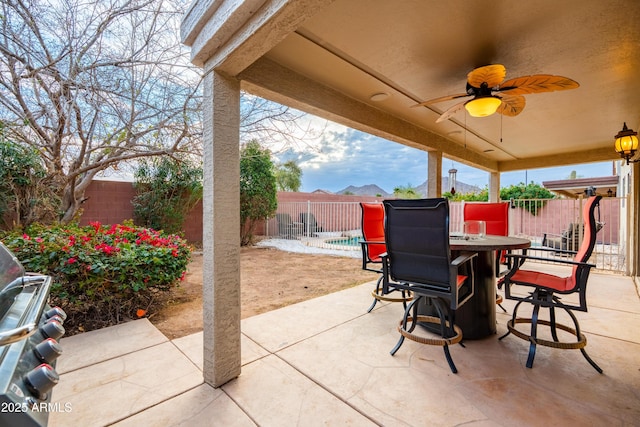 view of patio / terrace featuring ceiling fan, outdoor dining area, and a fenced backyard