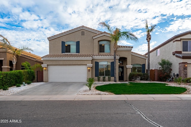 mediterranean / spanish-style home featuring driveway, a tile roof, fence, and stucco siding