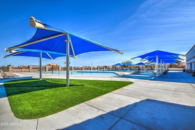 exterior space featuring a pool, a lawn, and a patio