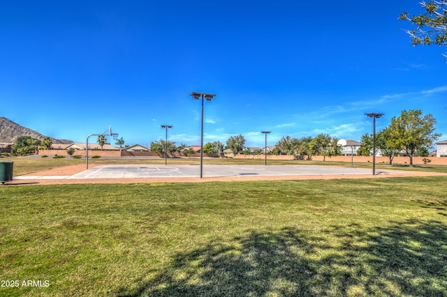 view of home's community featuring community basketball court and a yard