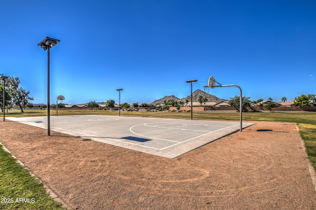 view of basketball court with community basketball court and a yard