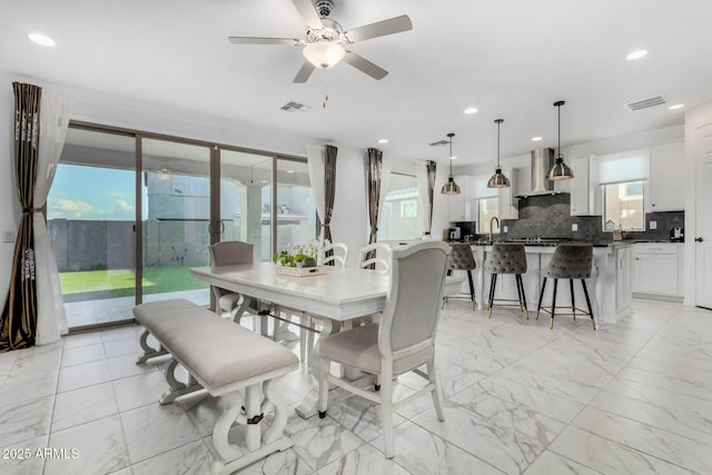 dining room featuring sink and ceiling fan