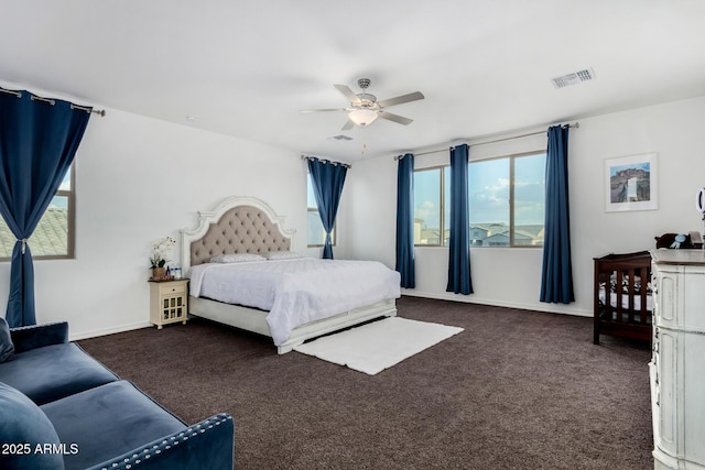 bedroom featuring ceiling fan and dark carpet