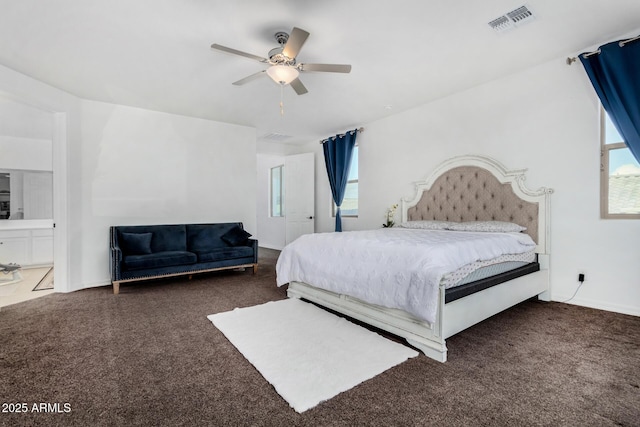 bedroom featuring multiple windows, dark colored carpet, and ceiling fan