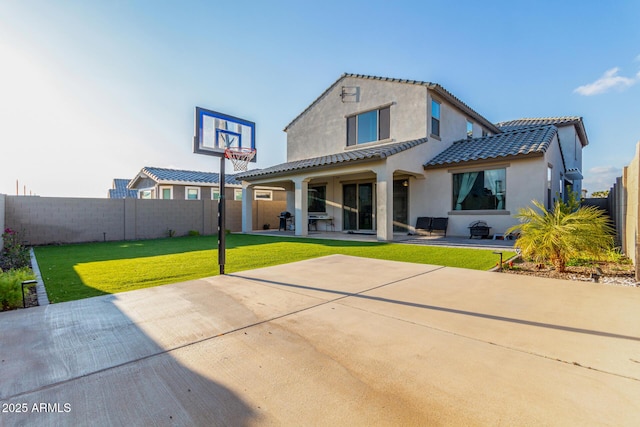 back of house with a yard and a patio area