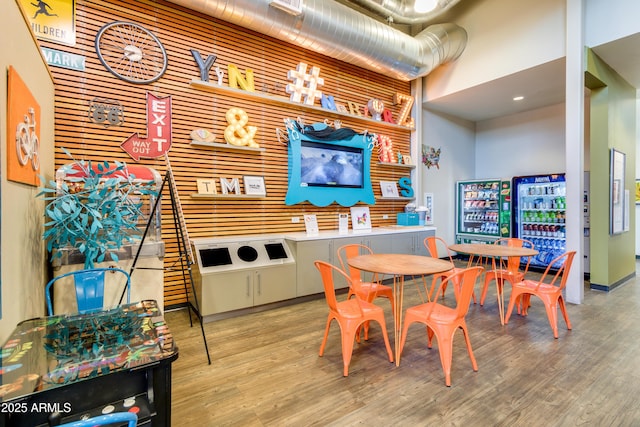 interior space with hardwood / wood-style floors and a high ceiling