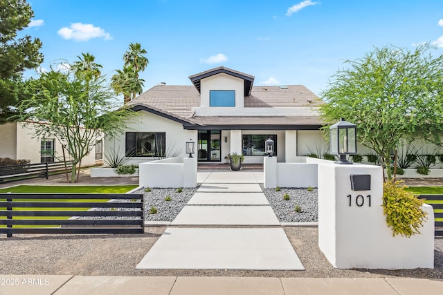 101 E Linger Ln, Phoenix, AZ 85020 - view of front facade featuring stucco siding, a fenced front yard, a porch, and a tile roof
