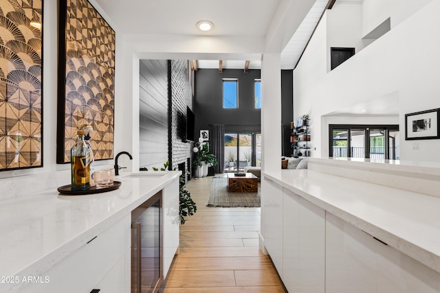 101 E Linger Ln, Phoenix, AZ 85020 - indoor bar featuring light wood-style floors, wine cooler, and a high ceiling
