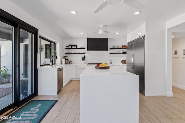 101 E Linger Ln, Phoenix, AZ 85020 - kitchen with open shelves, stainless steel appliances, modern cabinets, ceiling fan, and healthy amount of natural light