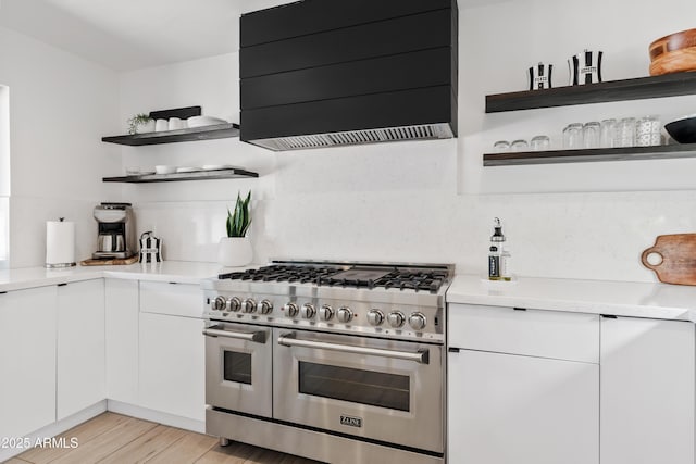 101 E Linger Ln, Phoenix, AZ 85020 - kitchen featuring open shelves, double oven range, wall chimney range hood, white cabinets, and light countertops
