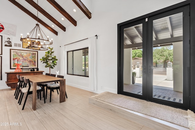 101 E Linger Ln, Phoenix, AZ 85020 - dining space with beamed ceiling, a chandelier, french doors, high vaulted ceiling, and light wood-type flooring