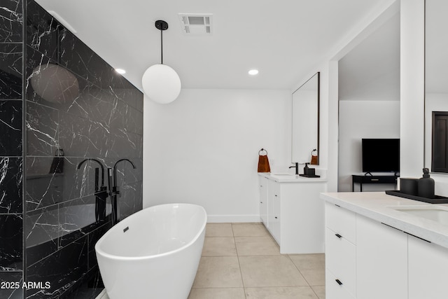 101 E Linger Ln, Phoenix, AZ 85020 - full bathroom featuring two vanities, a freestanding tub, tile patterned floors, recessed lighting, and baseboards